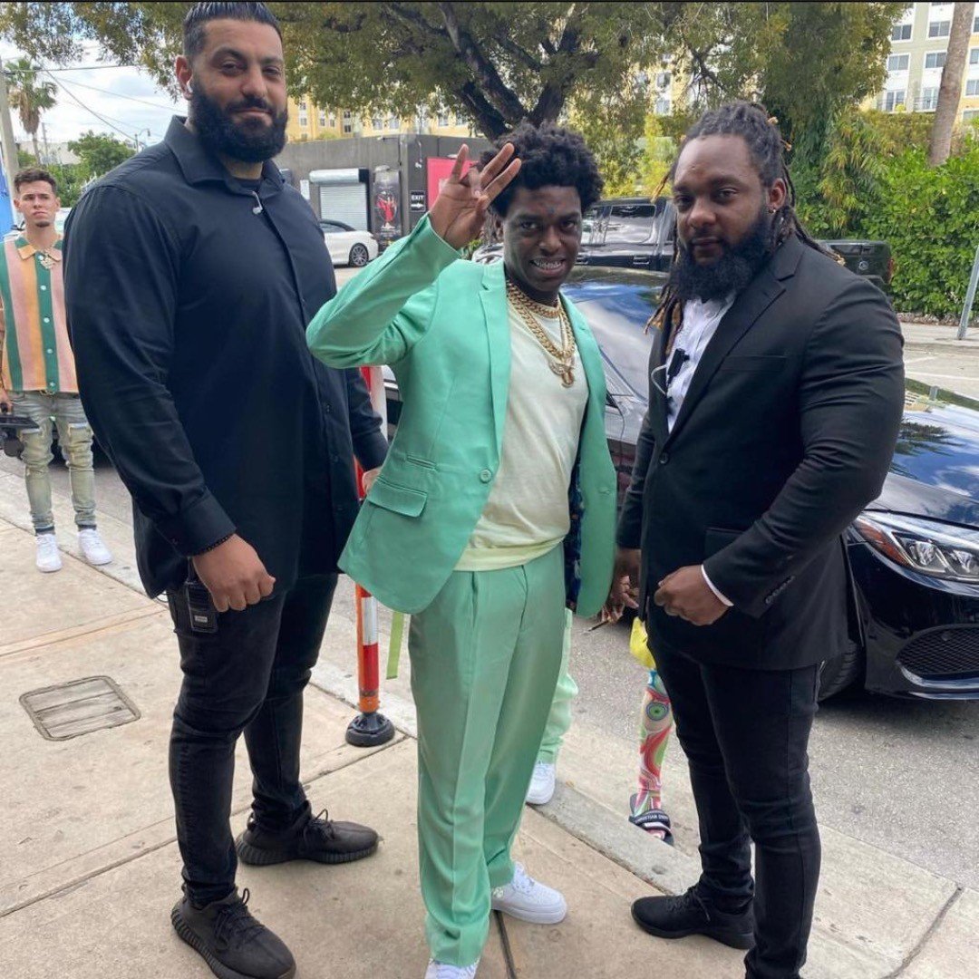 Two Spectrum executive protection agents escorting a recording artist on a Miami street