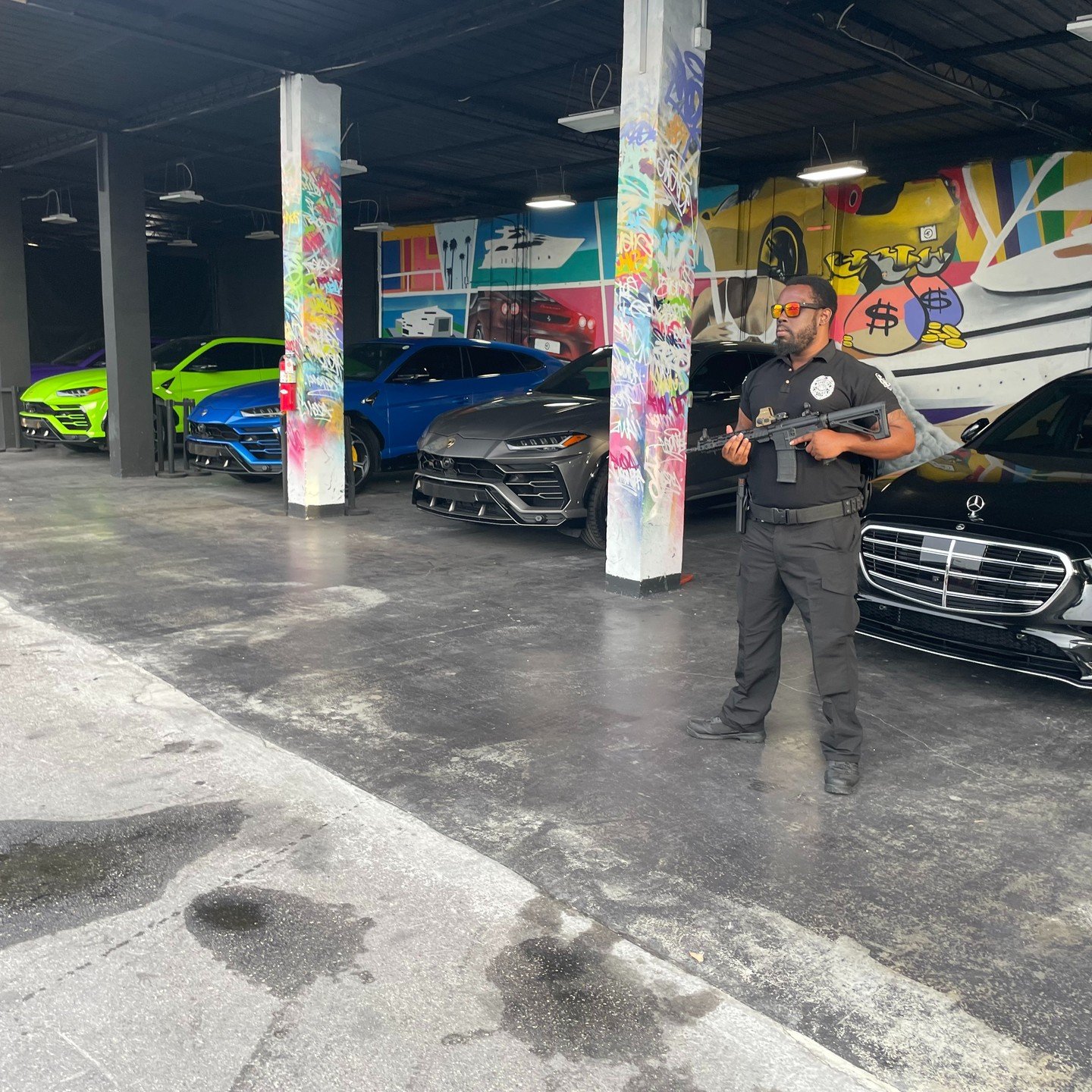 Armed Spectrum officer posted inside a private luxury car collection in Miami
