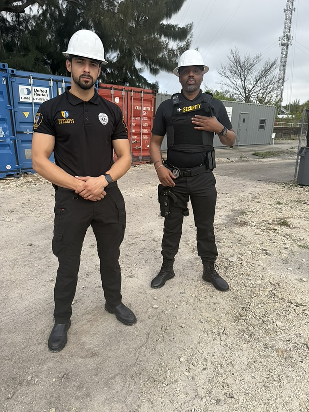 Spectrum Florida Security officers on a construction container site, hard hat on post