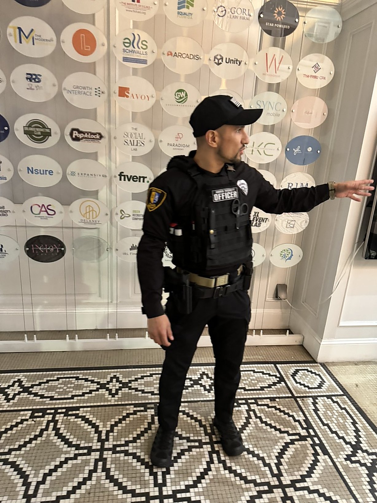 Spectrum Florida Security instructor briefing at a partner event wall